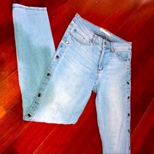 Light wash denim jeans frayed hem silver grommets